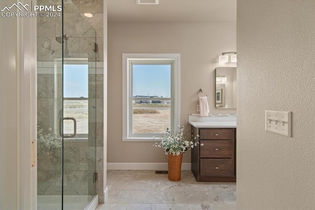 bathroom with vanity and a shower with shower door