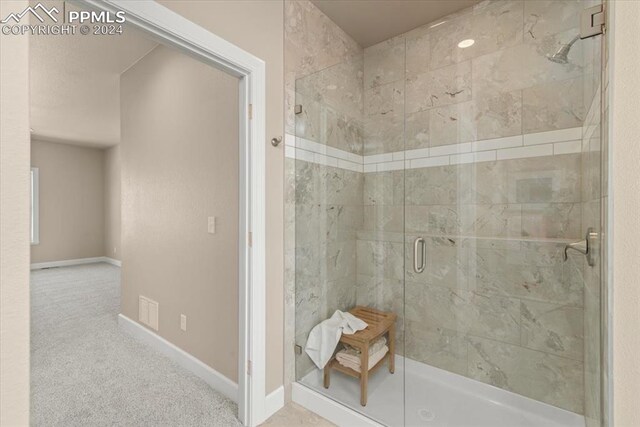 bathroom with a shower with shower door