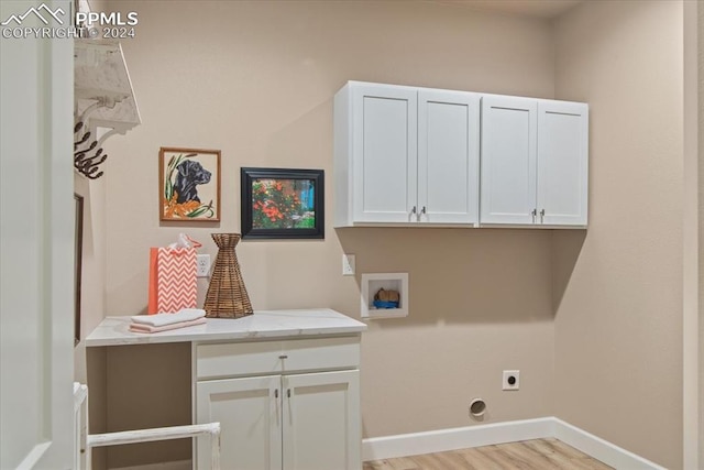 washroom with light wood-type flooring, hookup for a washing machine, hookup for an electric dryer, and cabinets