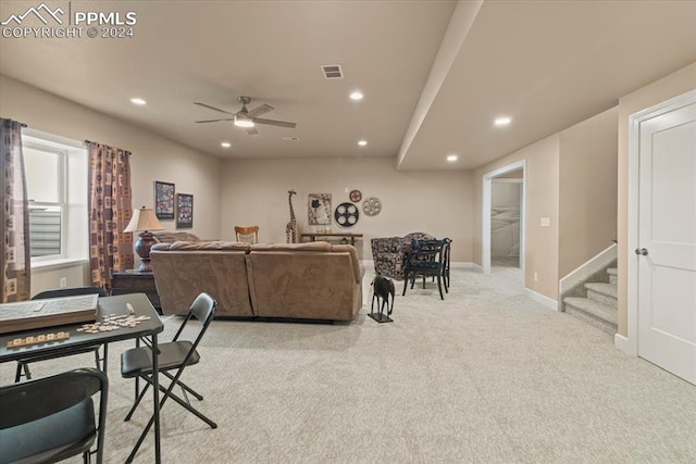 carpeted living room with ceiling fan