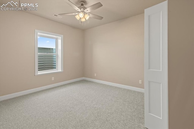 spare room featuring carpet flooring and ceiling fan