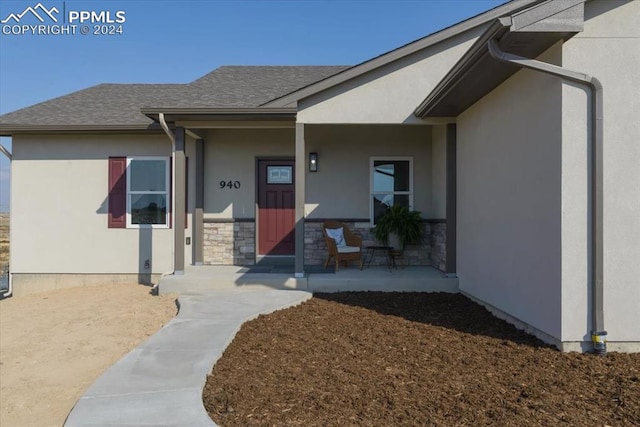 view of exterior entry with covered porch