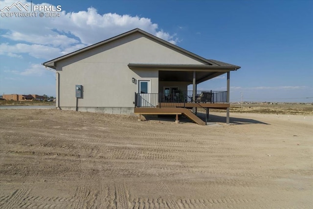 back of property featuring a wooden deck