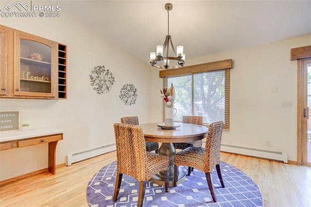 dining room featuring plenty of natural light, a baseboard heating unit, and light hardwood / wood-style floors