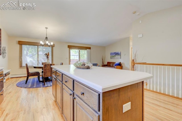 kitchen featuring light wood-type flooring, a center island, hanging light fixtures, vaulted ceiling, and an inviting chandelier