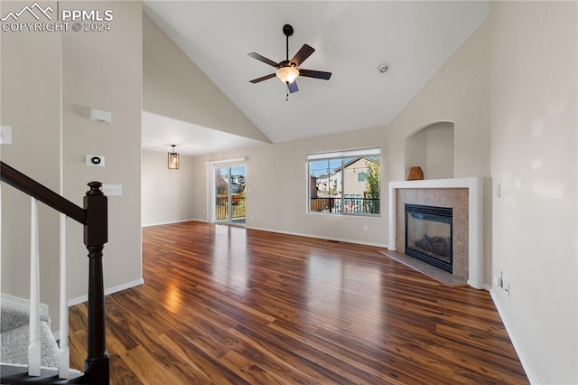 unfurnished living room featuring ceiling fan, high vaulted ceiling, a fireplace, and dark hardwood / wood-style flooring