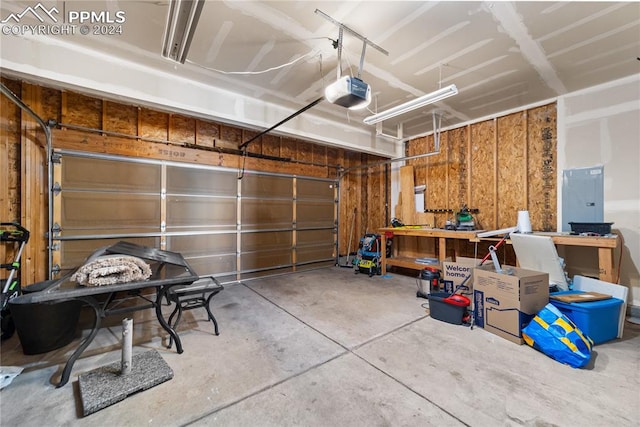 garage with a garage door opener, electric panel, and wooden walls