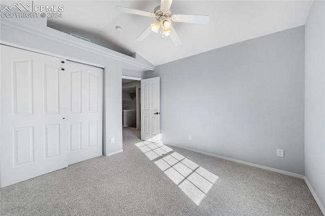 unfurnished bedroom featuring light carpet, a closet, ceiling fan, and vaulted ceiling