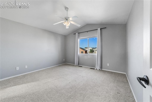 spare room with lofted ceiling, carpet flooring, and ceiling fan