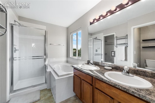 full bathroom featuring vanity, independent shower and bath, and toilet