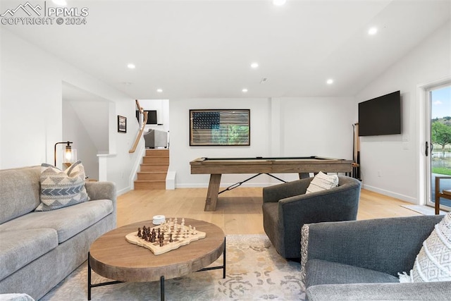 living room with light hardwood / wood-style flooring, pool table, and vaulted ceiling