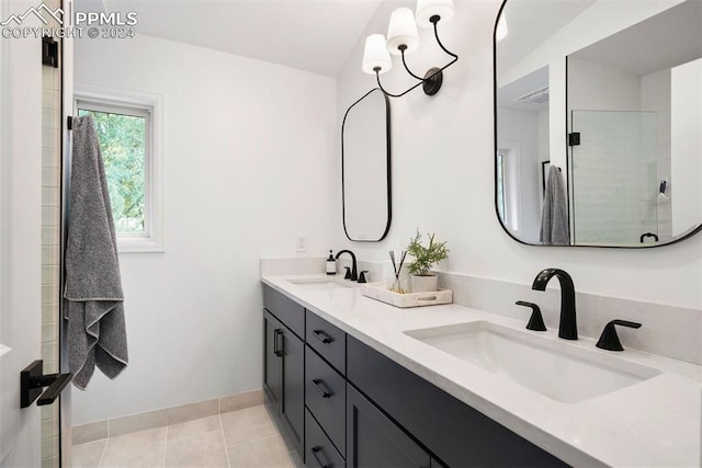 bathroom featuring vanity, a shower with door, and tile patterned floors