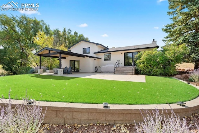 back of property featuring a yard and a patio area