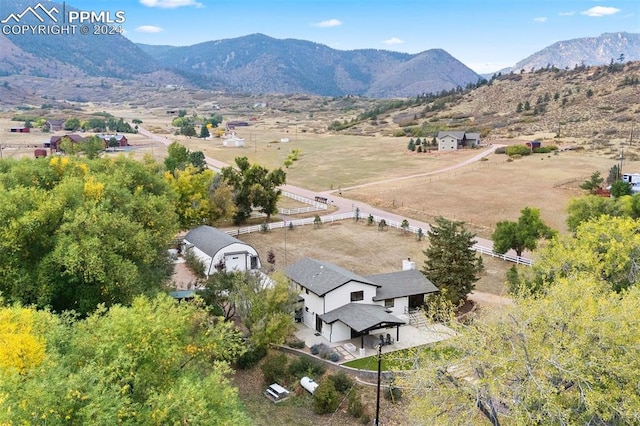 birds eye view of property with a mountain view