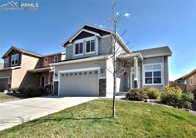 view of front of home with a front yard and a garage