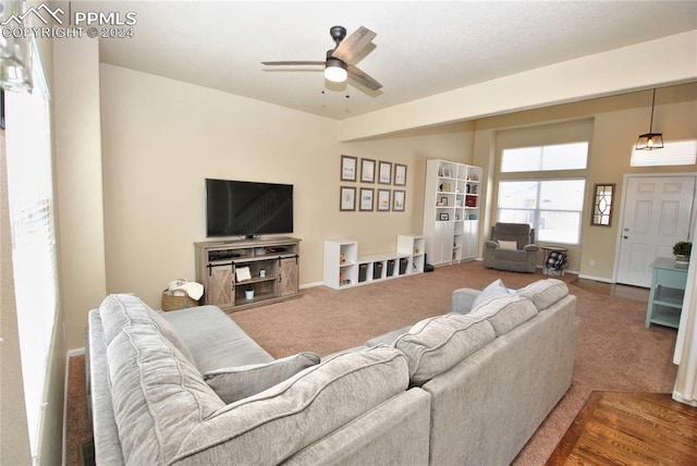 living room featuring ceiling fan and carpet flooring