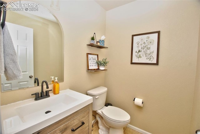 bathroom featuring vanity, toilet, and tile patterned floors