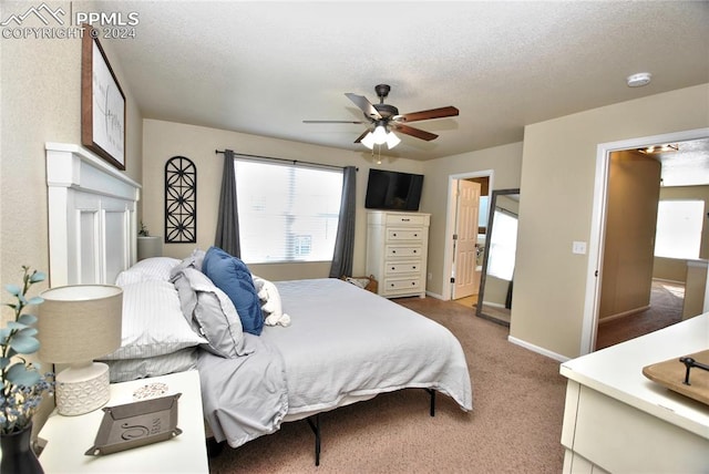 bedroom featuring carpet flooring, ceiling fan, and a textured ceiling