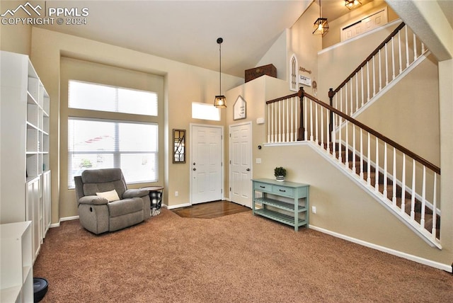 carpeted foyer featuring a high ceiling