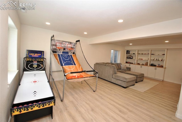 recreation room with light wood-type flooring