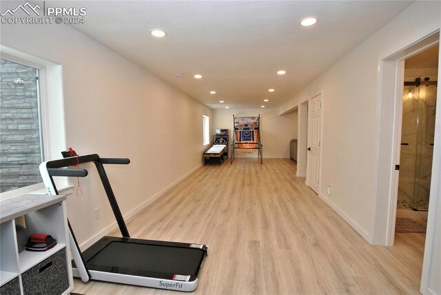 workout room with light hardwood / wood-style floors