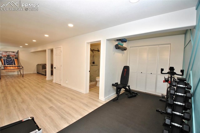 workout room with light hardwood / wood-style flooring