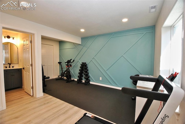 workout area featuring light wood-type flooring