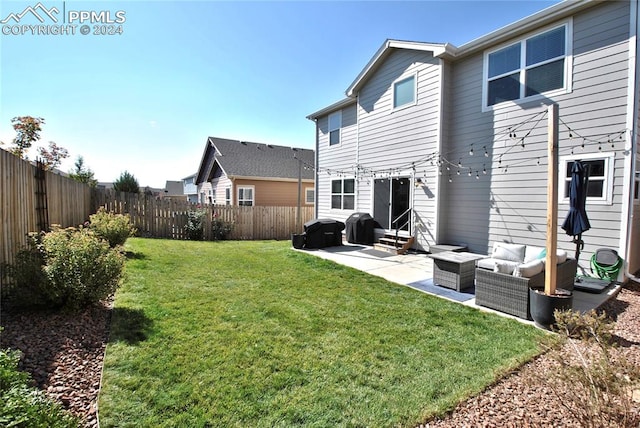 back of property featuring an outdoor living space, a yard, and a patio