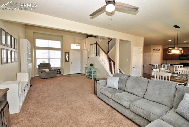 living room with ceiling fan and carpet flooring