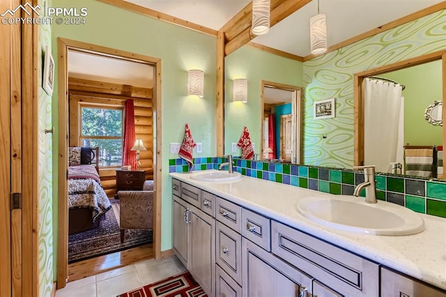 bathroom with vanity, tile patterned floors, rustic walls, and tasteful backsplash