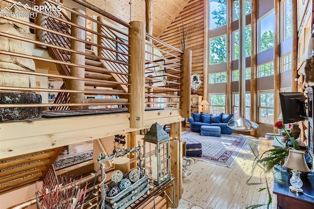 miscellaneous room featuring high vaulted ceiling and hardwood / wood-style floors