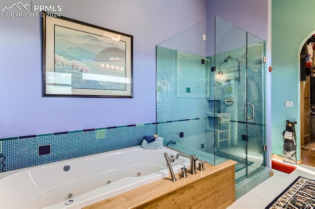 bathroom with separate shower and tub and tile patterned floors