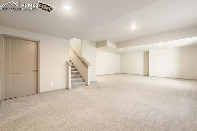 basement featuring light carpet