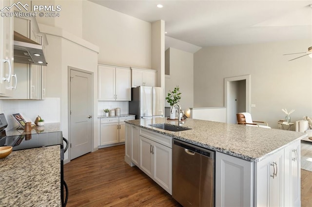 kitchen featuring appliances with stainless steel finishes, white cabinetry, hardwood / wood-style flooring, and sink