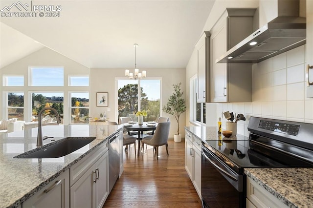 kitchen with black electric range oven, wall chimney range hood, dark wood-type flooring, hanging light fixtures, and sink