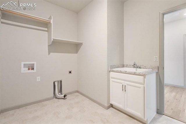 laundry room with sink, cabinets, electric dryer hookup, washer hookup, and light hardwood / wood-style flooring