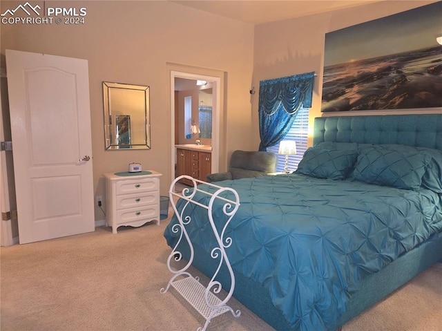 bedroom with ensuite bath and carpet