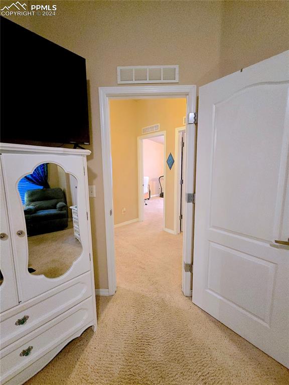 corridor featuring carpet floors and a textured ceiling