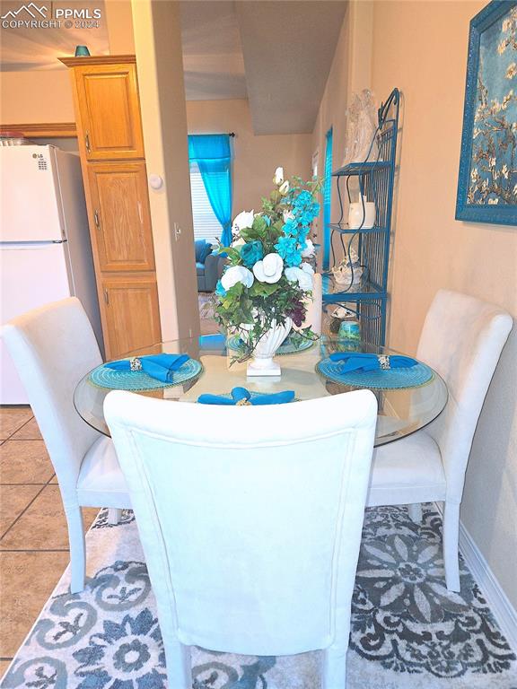 dining space with tile patterned flooring