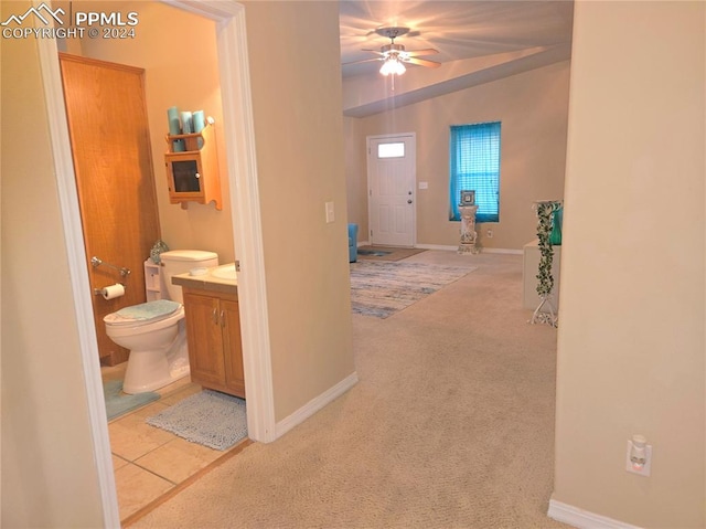 bathroom with tile patterned flooring, ceiling fan, vanity, and toilet