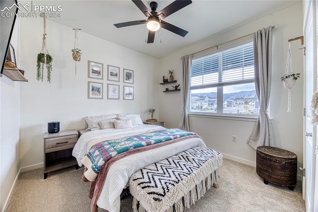 bedroom with ceiling fan and light colored carpet