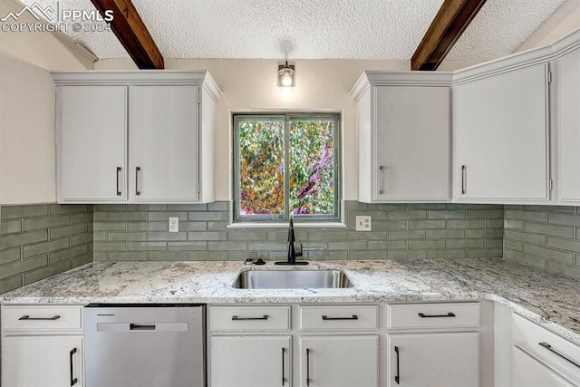 kitchen featuring dishwasher, backsplash, white cabinets, and sink