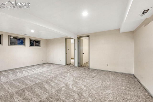 basement featuring light carpet