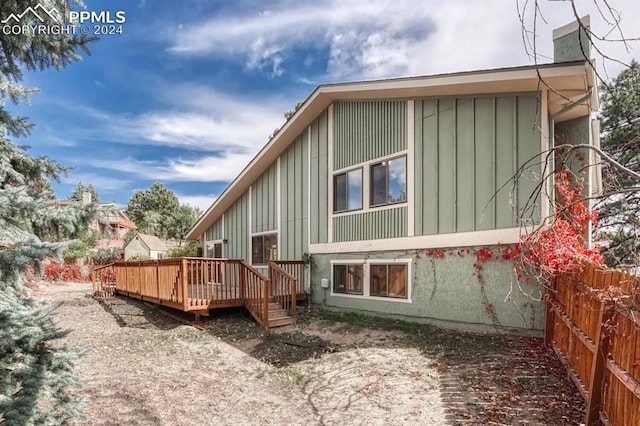 back of property featuring a deck