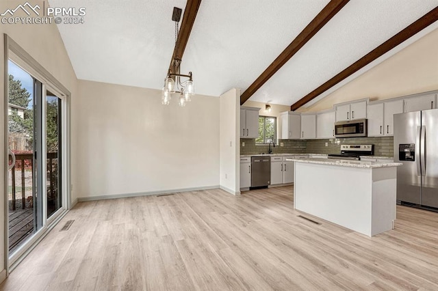 kitchen with a kitchen island, stainless steel appliances, hanging light fixtures, light hardwood / wood-style flooring, and beam ceiling