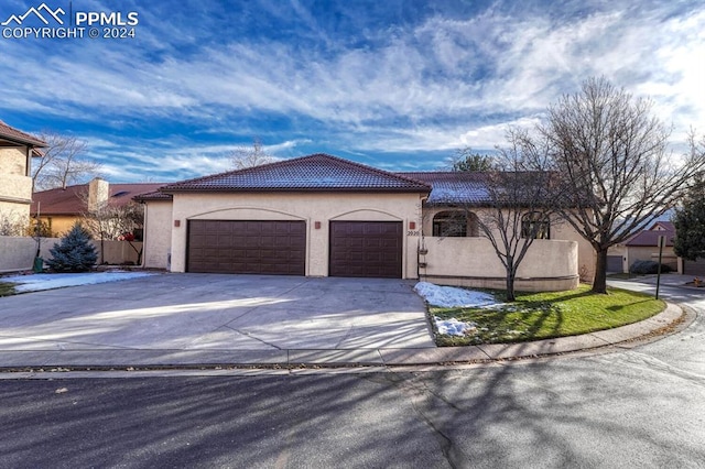 mediterranean / spanish-style home featuring a garage