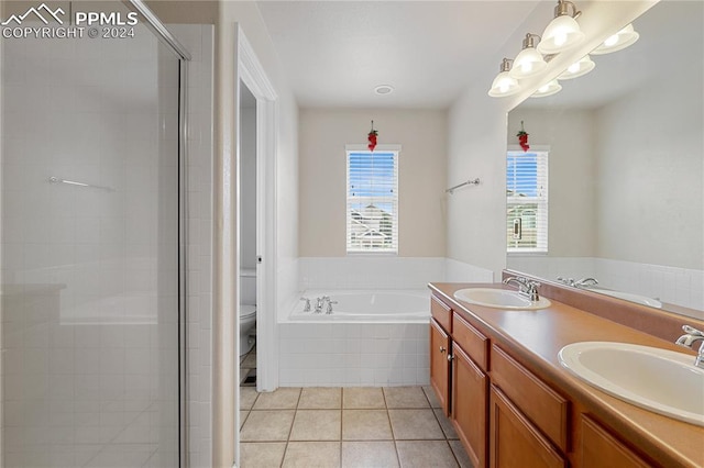 full bathroom with vanity, independent shower and bath, toilet, and tile patterned floors