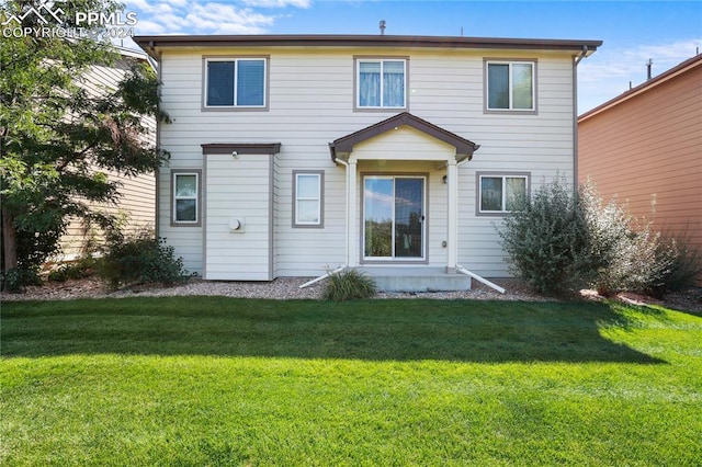 rear view of house with a lawn