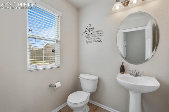 bathroom with toilet and tile patterned floors