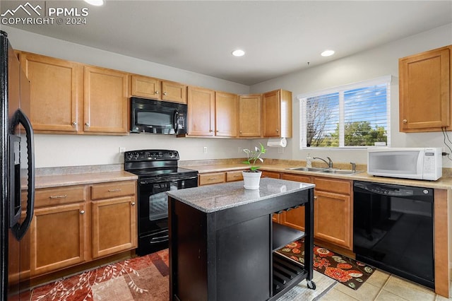 kitchen featuring sink, black appliances, light tile patterned flooring, and light stone counters